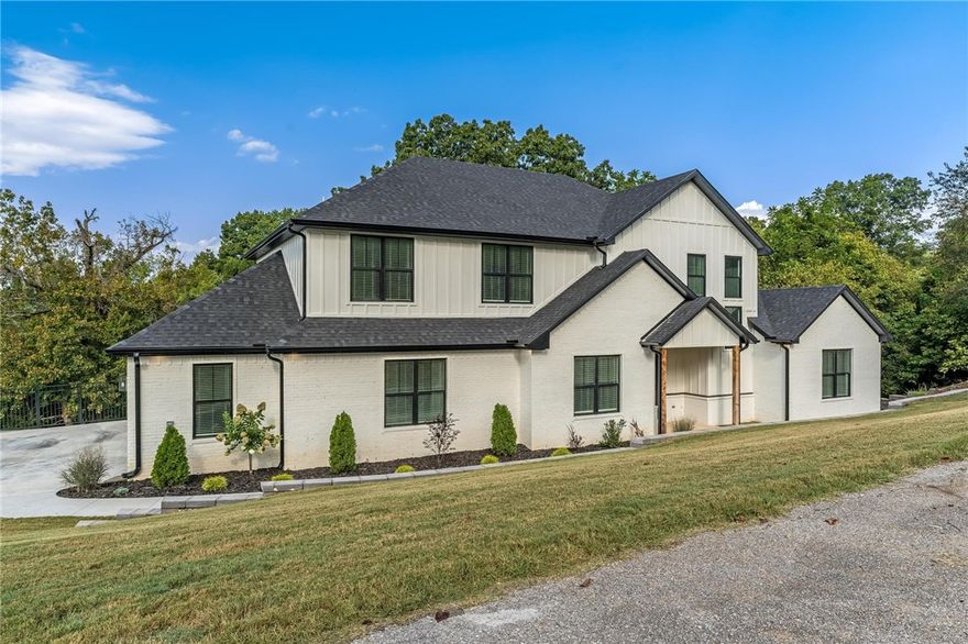 Welcome to Bentonville's sought-after Eau Claire subdivision. This 4-bedroom, 3.5-bath home sits on 1.25 acres and showcases gorgeous valley views, offering both privacy and convenience. With 3,307 SF of thoughtfully designed living space, the home features an upstairs bonus room for movies, school, or play, plus a dedicated office with a custom accent wall. Inside, discover a chef’s kitchen with luxury finishes, oversized island, and walk-in butler’s pantry—perfect for entertaining. The spacious floor plan includes abundant storage and a 900 SF garage with custom epoxy floors, ideal for projects or extra parking. Three heating and cooling units ensure comfort year-round. Step outside to the expansive deck overlooking the valley—an inviting space for gatherings or quiet evenings. Located in Bentonville School District, this home is minutes from trails, parks, and vibrant downtown Bentonville. If you’re searching for Bentonville homes for sale with acreage, style, and comfort, this one checks every box.