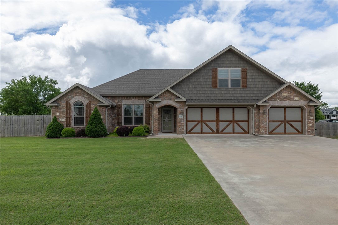 A corporate rental or long term rental don't miss this unrestricted almost an acre lot.The home welcomes you in with an open floor plan and double sided, kitchen/living room gas log fireplace.High ceiling and large living area is modern and trimmed perfectly.Three full baths include a walk-in shower in primary bedroom with Jacuzzi tub.Custom cabinets throughout and the trim level you want.Primary has three closets for plentiful storage.Walk in closets in all of these oversize bedrooms! Natural light/large windows abound.Attic walk-in storage and plentiful storage in 3car oversized garage. The modern kitchen features two pantries, gas 5 burner cook top, built in oven and microwave, along with a large eat-in dining room.The backyard features a gas fireplace for lounging, ready with your TV to watch the hogs and is large enough to host your entire family, and even build a pool.Backyard is perfectly positioned for a garden.