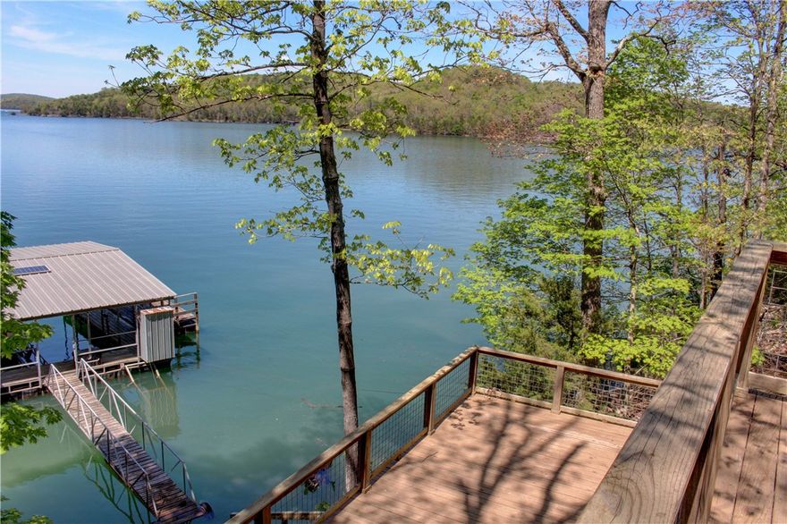 Discover the ultimate lakefront retreat on 3.76 private acres, complete with a two-slip private boat dock and multiple decks perfect for entertaining or relaxing with beautiful lake views. This 3-bedroom, 2.5-bathroom home offers an open-concept design that seamlessly connects the kitchen, living, and dining areas—ideal for gatherings and everyday living. Thoughtfully designed for both comfort and functionality, this property offers incredible privacy and the potential to divide or expand. Wake up to serene water views, spend your days on the water, and unwind on the expansive decks surrounded by nature. Whether you're looking for a personal lakefront sanctuary or an investment with development potential, this rare gem has it all.