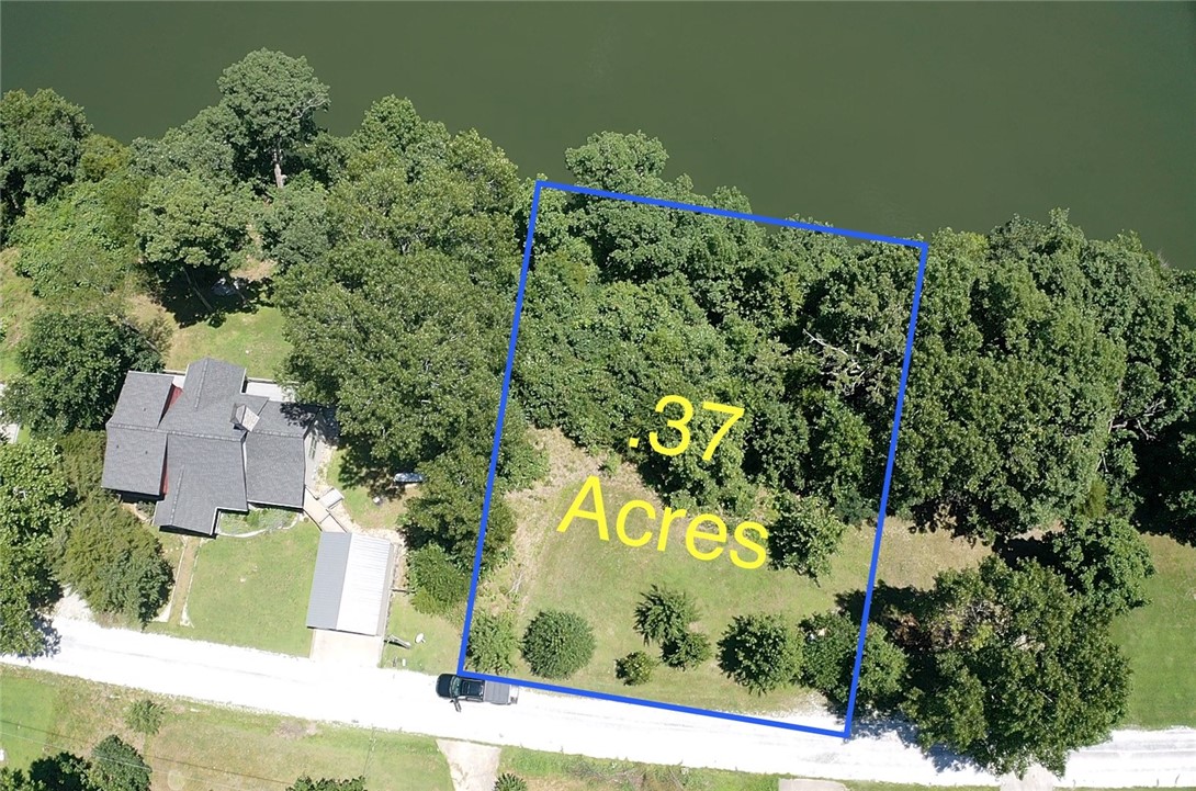 Fabulous Lakefront .37-acre lot on beautiful Beaver Lake, ready to build your dream home! Nestled in a peaceful setting where nature abounds, just minutes from downtown Springdale, this rare find offers stunning water views year-round. Utilities available at the road, (septic needed) gently sloped terrain ideal for construction, and a quiet neighborhood perfect for weekend getaways or full-time living. Enjoy the best of both worlds—serene lake life and the convenience of nearby shopping, dining, and entertainment. Don’t miss your chance to own a prime piece of lakefront property in booming NWA!