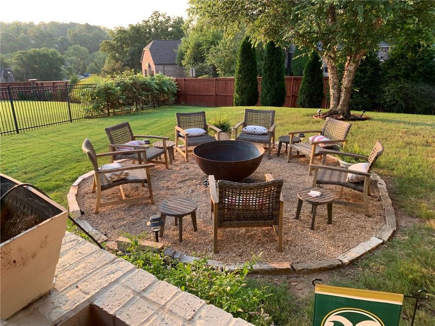 Located on a premier corner lot in the sought-after Chapel Hill subdivision, this custom-designed four-bedroom, four-bath home showcases timeless architecture and elevated living. Crafted with intention, the home features two fireplaces, stained concrete floors, and light-filled living spaces throughout. The main level offers a serene primary suite, a guest suite with ensuite bath, and a cozy study with custom built-ins and oversized 7-foot windows. A beautifully appointed kitchen with custom island and dining area opens to a spacious living room ideal for entertaining. Upstairs are two additional bedrooms with a Jack-and-Jill bath and a large bonus room with custom built-ins and a full bath. Outdoor living includes a covered back porch with porch swing, custom shades, ceiling fans, and a built-in grill and smoker, plus a flagstone path to a fire pit. A three-car garage with storage completes the home, ideally located near Crystal Bridges, the Walmart Home Office, bike trails, and downtown Bentonville.