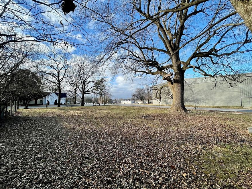 Prime Downtown Springdale corner lot—approximately 0.18 acres—perfectly positioned for your next project. Zoned Neighborhood Center Type 2 (NC-2), this property supports a variety of multifamily and mixed-uses, and is governed by the Downtown Form-Based Code, encouraging high-quality, plus flexibility in development. The lot features some beautiful, mature shade trees in historic downtown, offering unique character and a welcoming, established setting.  This property is ideally situated across from The Medium (formerly the Arts Center of the Ozarks), just 0.2 miles from the Razorback Regional Greenway bike trail, and close to numerous dining, shopping, and entertainment options. This is a rare opportunity to build in the heart of Springdale’s vibrant and growing downtown.