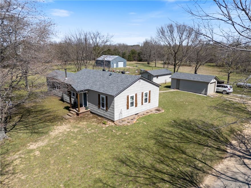 Escape to your private retreat on 9.37 acres m/l, just 20 minutes from Fayetteville or Huntsville. This restored 1951 home, remodeled in 2017, offers 1,152 sq ft of comfortable living. The open concept main room boasts bamboo flooring and a Harmon wood stove with glass front.  Recent water heater and softener, plus a mudroom for easy cleanup. 

The property includes multiple quality outbuildings, featuring a fully insulated 30x40 shop, provision building with electricity, and additional garage/storage space. Enjoy a pond, garden area, fire pit, and a modernized outhouse near outdoor spaces.

A 75-ft well with Bison pump and dedicated outdoor watering provide reliable water access. RV pad with 50-amp hookup adds convenience for guests. A peaceful, functional property designed for comfort and country living.