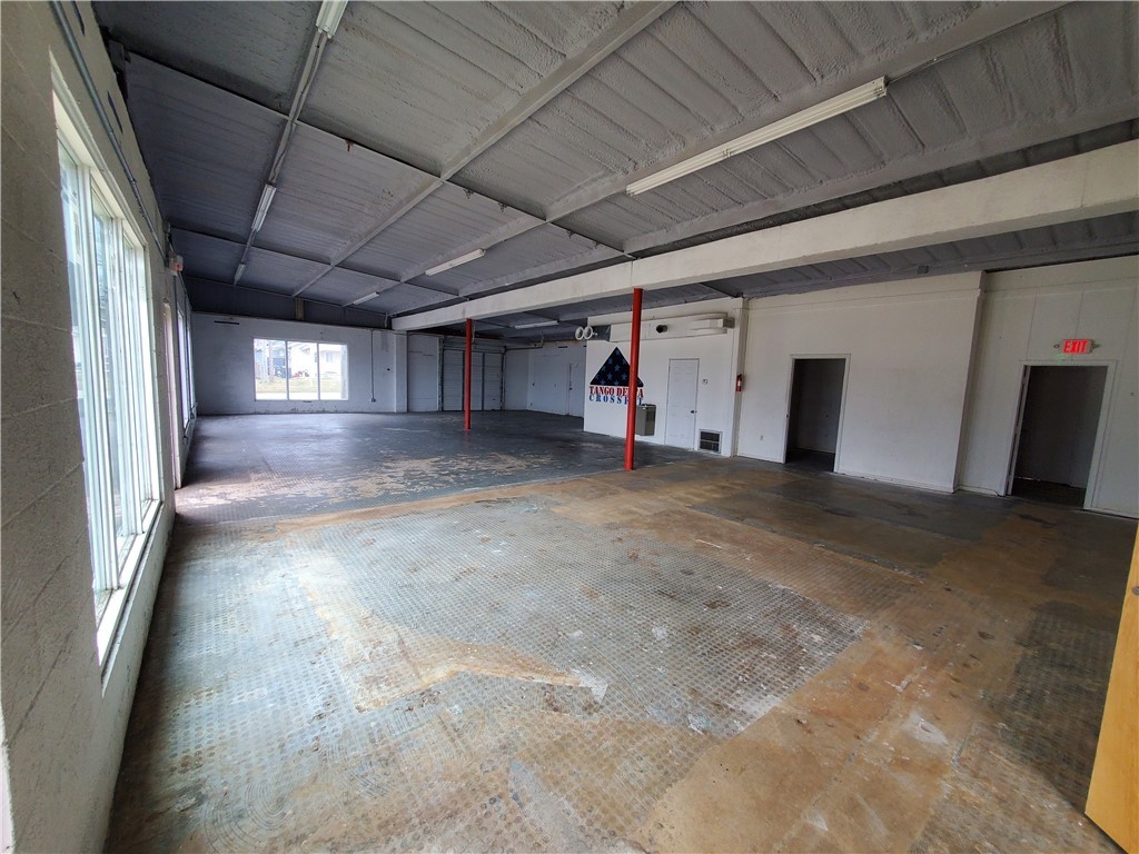Prime location in Downtown Rogers with private parking. 3200sf of wide open interior and office/retail space. This property is right next to Ozark Beer Company and steps away from the Entertainment District of Downtown. This space has 2 bathrooms and a fully built out shower. Tall ceilings with a garage roll-up door. Lots of potential for a variety of uses.