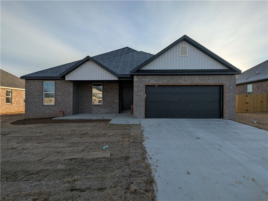 This lovely one-story home is brand new, sporting a classic masonry look with straight edges and a friendly front porch. There is plenty of room for vehicles on the wide cement path heading to the two-door garage. The outside is built to last and looks great with very little upkeep. Outside, the yard is a fresh start for your plants, and the muted colors go with everything. This property is great for anyone wanting a new house with a traditional feel in an up-and-coming area.