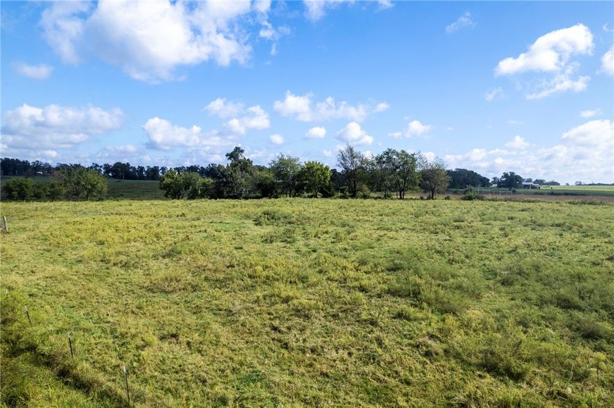Beautiful 7.5 acres in Bentonville that’s mostly flat, cleared, and build-ready. A pond and barn convey, offering immediate utility for storage, animals, or future hobby-farm plans. Plenty of room for a custom home, shop, and outdoor living while keeping wide-open views. You're less than 20 minutes from XNA and downtown Bentonville, this is for sure a property to see! This tract is being split from a larger parcel - final acreage and property boundaries are subject to change upon completion of the new survey and any required approvals. Any boundary lines shown in marketing are approximate. The property is currently on a well; public water is located across the road and may be connected with City approval.