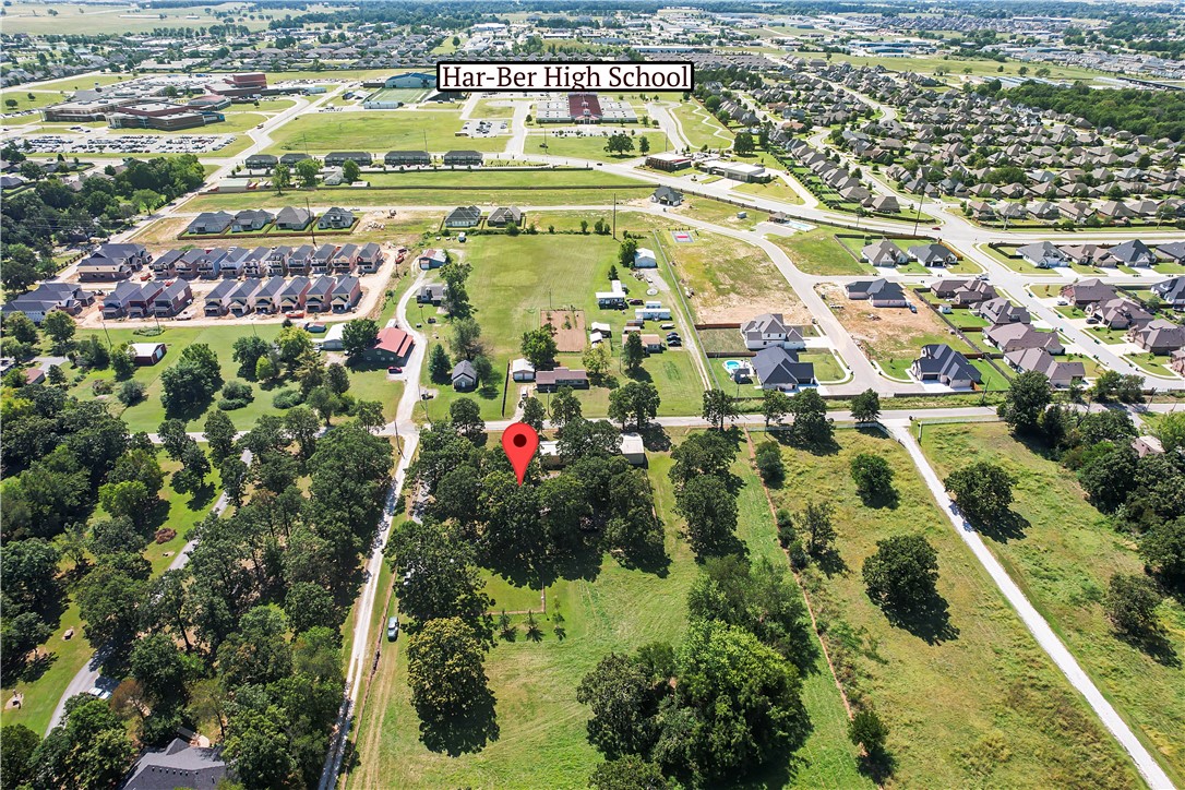 Well maintained home located close to Harber High School and Lake Elmdale on 5 beautiful park-like acres. This home has 4 bedrooms, an office/exercise room, 2 full baths, 1 half bath and 2 living areas. The utility room is spacious enough for 2 refrigerators and 1 freezer. The large patio/deck area is great for entertaining. The 30x60x12 shop building includes a half bath and a 12x60 lean to with 3 garage doors. It also has a room large enough for family gatherings. In front of the shop is a 24x40x12 carport large enough to store an RV. This is a great opportunity to have 5 acres and a nice home in the middle of town.