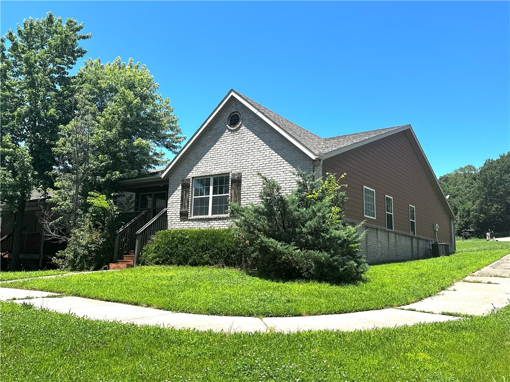 Big price drop, get it while it's hot, on this brick home in a highly desirable Fayetteville location on a corner lot just across from Walmart and Lowes on MLK. Conveniently located near the University of Arkansas, I-49, shopping, and dining. This home features a large open living room with fireplace that leads to huge kitchen with a huge dining area. The kitchen has plenty of wood cabinets and lots of granite counter space to work and cook. All appliances convey including the washer, dryer and refrigerator. Primary bedroom features tray ceiling and ensuite with dual vanities and a large walk-in-closet. Two more spacious bedrooms up front for the kids and a bathroom. 2 car garage with driveway parking allows for multiple vehicles and laundry room off the garage. Out front you can relax under the covered front porch. This is a great opportunity for a family seeking an affordable home or an investor seeking strong rental potential and long-term value in a fast-growing area of Fayetteville for student housing.