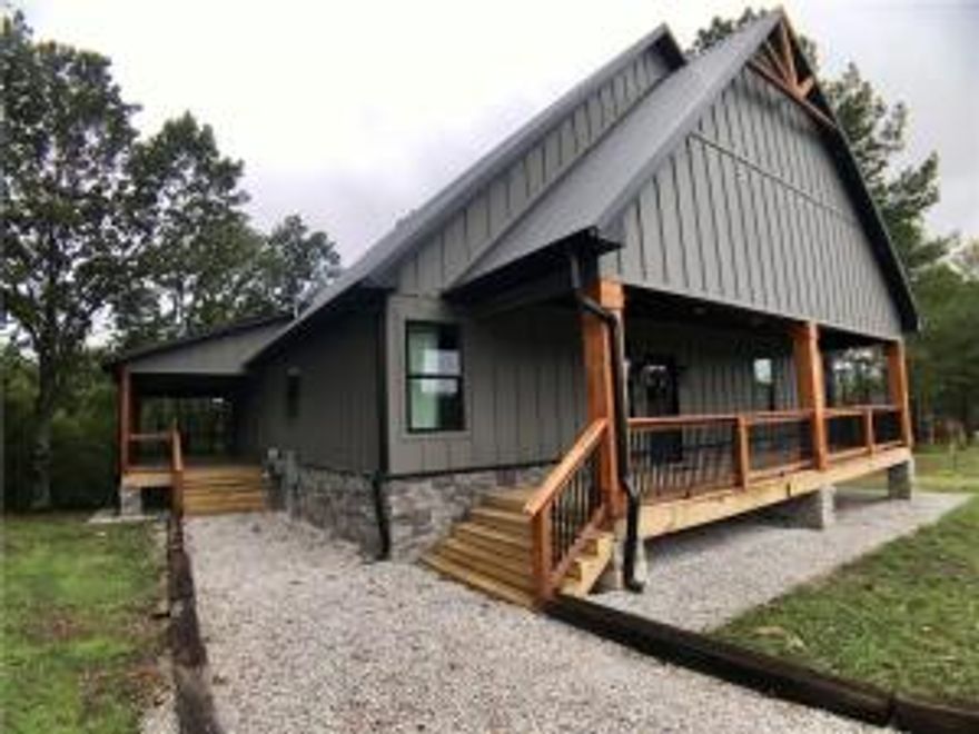 Located on the Kings River just 15 minutes from downtown Eureka Springs. Serene & peaceful this majestic cabin has views of the Kings River and so much natural light. The kitchen is equipped with a 5 burner commercial range, oversized island with marble counter tops, and pass through windows to outdoor seating! In the living room you will find the grand fireplace, vaulted pine ceiling, and views, views, views! On a cool night, relax outside with the outdoor fireplace on your wrap around deck gazing at the river! Downstairs the primary bedroom has a walk in closet, large bathroom with a soaker tub & oversized walk-in shower. On the other side you'll find 3 additional guest rooms and two full baths. Upstairs there is a loft that can be used for lounging, gaming, or sleeping.