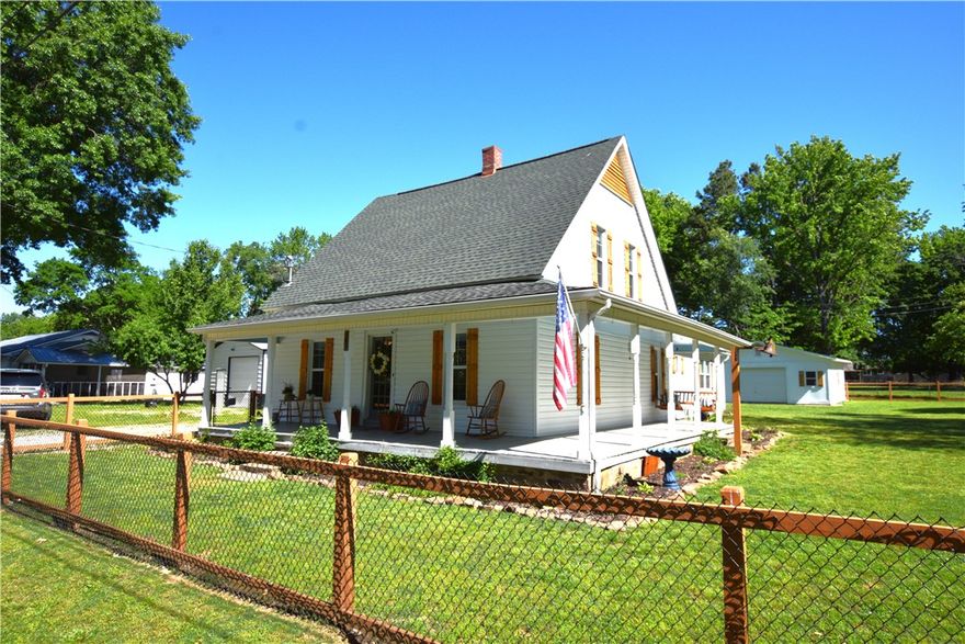 Charming Historic Farmhouse in the Heart of Prairie Grove! This beautiful 4-bedroom, 2-bath farmhouse sits on a spacious .52 acre m/l lot right in the heart of Prairie Grove, offering the perfect blend of character and modern updates.  Step inside to find newer laminate flooring and a warm, inviting layout featuring a cozy fireplace in the kitchen—perfect for gathering and everyday living. The kitchen is equipped with stainless steel appliances, all less than 3 years old (excluding stove).  Recent updates include a newer roof on both the home and detached 1-car garage, plus the garage has been fully insulated—great for storage, hobbies, or workspace. The entire siding on the home has also been replaced, giving it fresh curb appeal and added peace of mind.  Outside, enjoy a nice front porch, established flower beds, and a chain-link fenced yard, all on a generous lot with room to spread out and enjoy.ous lot with room to spread out and enjoy.