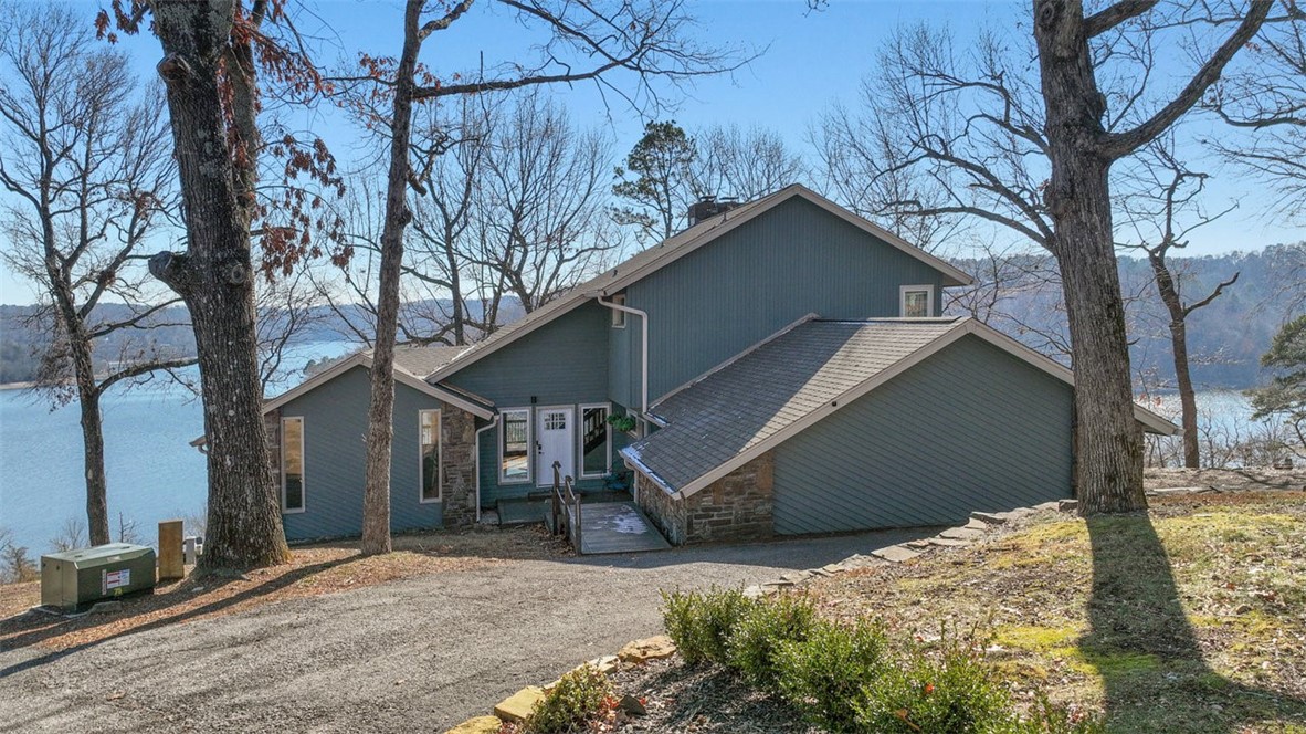 Come experience this beautifully remodeled Beaver Lake home just 10 Minutes from downtown Rogers. All furnishings included with a full price offer. The panoramic 180-degree Beaver Lake perspective steals the show - your eyes will be drawn to the water and all the wildlife that abounds in this area. The home boasts 3 fireplaces, a library serving the primary bedroom suite and $200K in recent high-end upgrades in addition to recent roof and a world class hot tub from which to enjoy the view. An outdoor stone fire pit area is great for gatherings. The photos here have not been touched-up - what you see is what you get. The 2-car garage is oversized. Corps property does exist between the property and lake as is usual for Beaver Lake and rules as to how corps property can be utilized exist so be advised. A public boat launch is just 4 minutes away. Additionally, there is a "neighborhood lake access" for kayaks, row boats and a swimming area around the block. See kitchen counter for directions. Have fun.