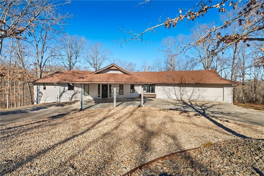 Step inside this beautifully maintained and updated home, where thoughtful design meets effortless functionality. With 3 bedrooms and 3 full baths, including two primary suites and a bedroom with an adjacent guest-friendly bath, this home offers privacy and comfort for everyone. The split floor plan floods with natural light and highlights a spiral staircase leading to a heated/cooled 333 sq. ft. workshop below—perfect for a hobby studio or bike space. (not included in sq. ft.).
Enjoy cozy evenings by the gas fireplace with blowers, or entertain on the expansive back deck. Recent updates include a 4-year-old HVAC and roof, brand-new water heater, whole-house water filter, and recently pumped septic tank.
Sitting on two lots with a fenced backyard, this home offers a circle drive with portico and RV hookup with charging box. Located just around the corner from The Branchwood Recreation Center with an indoor pool, trails, and courts, this property combines charm, comfort, and the best of the Bella Vista lifestyle!