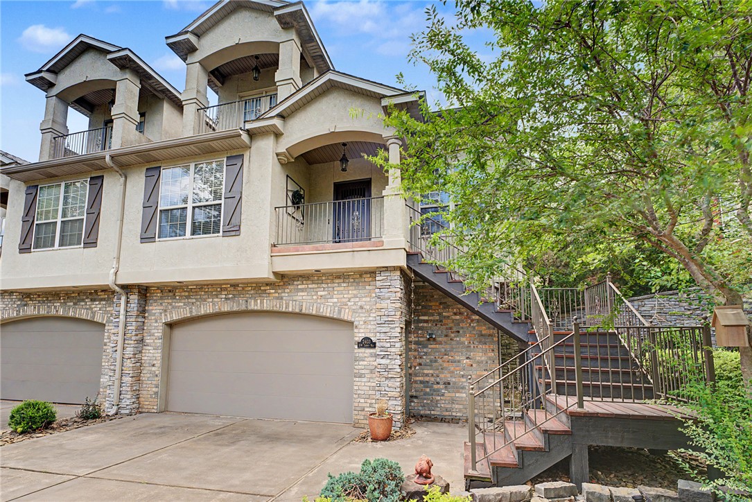 View of front of home with a balcony, stucco sidin