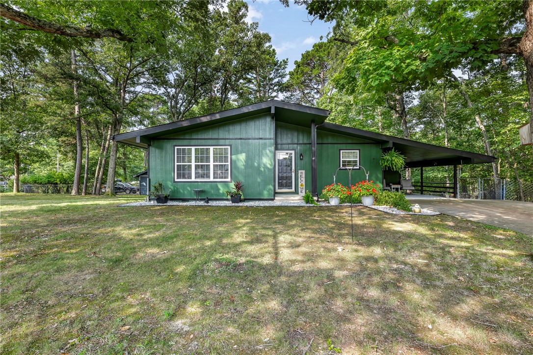 Great property for Home Sweet Home or an investment (long-term rental or Airbnd). Great location! Near Bentonville, Hwy 71, I-49, school, medical, shopping, restaurants, trails, and Bella Vista amenities. Exceptionally clean & well-maintained. 2 bedrooms & 1.5 baths. 2 closets in each bedroom. The following are only a few years old: interior & exterior paint, walk-in shower, roof, gutters, HVAC, water heater, appliances, garbage disposal, countertops, luxury vinyl throughout. Has double pane windows, storm doors, amazing 12' sliding glass door which provides natural light into main living area. Also, many windows in both bedrooms provide natural light; entire home is inviting/comfortable. A large deck (8'x18') on a corner lot (.34 acre) with wonderful trees and landscaping. The area on one side is POA property; great for privacy and wooded natural setting. Fenced back yard. In addition to central heat/air, there is a wood stove that works great. The kitchen has a counter for bar stools. Storage building (7.5'x10').