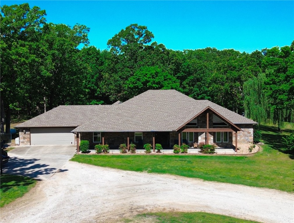 Beautiful secluded 4 bdrm 2 bath home nestled on 7.5 ac. Plenty of room for entertaining whether in the large living room with its vaulted ceiling and tons of natural lighting, back patios, spacious yard or the 3,700 sqft shop/garage that can be used for large gatherings. Shop is equipped with 200 amp and has full bath. Granite countertops in kitchen. Built in china cabinets in the dining room. Double vanity in mstr bath and walk-in closet. Built in safe room/ storm shelter in the home with concrete walls. Home also has a whole house generator. New roof and HVAC in 2018. Truly a must see!!!