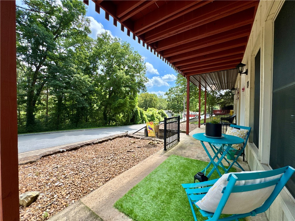 Completely Renovated Townhome with a beautiful view year round! Step into this remodeled 2-bedroom, 1.5-bath, two-story townhome where nearly everything is brand new! Enjoy peace of mind with updated plugs, switches, recessed lighting, and ceiling fans. The home also features fresh drywall and paint throughout, luxury vinyl plank flooring, and new carpet. The kitchen has granite countertops and stainless steel appliances—all of which convey and are less than a year old. Bathrooms are updated with stylish matte black fixtures and feature modern electric mirrors for that extra touch of luxury. Upstairs, a new sliding glass door opens to a private balcony off the bedroom with beautiful wooded views. Laundry room is located convenient to the bedrooms and master bathroom, washer and dryer is less than a year old and conveys. The front porch also offers a peaceful spot to relax. Located conveniently to trails, country club, golf, lakes, and pools.