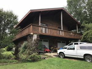 VERY PRIVATE Hobby Farm!! 1,920 SF, 3BR-2BA home on 40+ acres with year-round SPRING and CREEK, shop, green house, garden room, pasture and more!! This bright, 2 story country home features 2 kitchens, wood stove, some tile and laminate flooring, a large covered porch, walk-in closet, attached 2 car garage and backup propane wall heaters in addition to central heating and air. Walk outside and enjoy the raised bed garden, 24x30 shop, 12x16 garden room perfect for crafting or reading room, flower beds, fruit (peach, pear, and cherry) trees and large shade trees! Plenty of good pasture for horses, cattle or goats plus the year round spring and creek! This is an outdoor enthusiasts dream!
