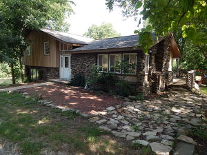Spacious Home 5 acres and shop just outside of Berryville, 2 creeks, 5 BR's 3BA, with 2 Master BR's, one on upper level and one on lower level, office or workout space on lower level, extra den, pantry, lots of storage, 30x30 shop with own electric meter, silestone counters, custom cabinets, zone control HVAC, storage building, double carport, room for horses, landscaped, koi pond, with deck and lots of nice shade. Newly remodeled. Rural water easement signed and natural gas across the road.