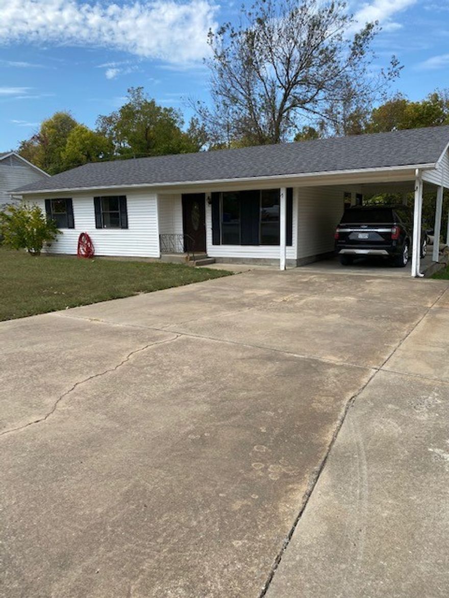 Welcome to this solid 3-bedroom, 2-bathroom home with real potential! This single-level, 1,072 sq ft home sits on a generous 0.26-acre level lot within the highly regarded Gravette School District. Currently tenant occupied, it's a fantastic investment opportunity with immediate income potential. Inside, you'll love the glass cooktop, electric range, and microwave vent, making the kitchen both functional and stylish. Ceiling fans and a washer/dryer connection add everyday convenience. Step outside to a beautifully fenced backyard shaded by mature trees — perfect for relaxing on the patio or letting the kids and pets roam freely. A 120 sq ft storage building adds bonus utility. The attached carport and concrete driveway round out the practicality. With central gas heat, central electric A/C, an architectural shingle roof, and low annual taxes of just $1,096, this home checks all the right boxes — whether you're an investor or a savvy first-time buyer. Schedule your showing today!
