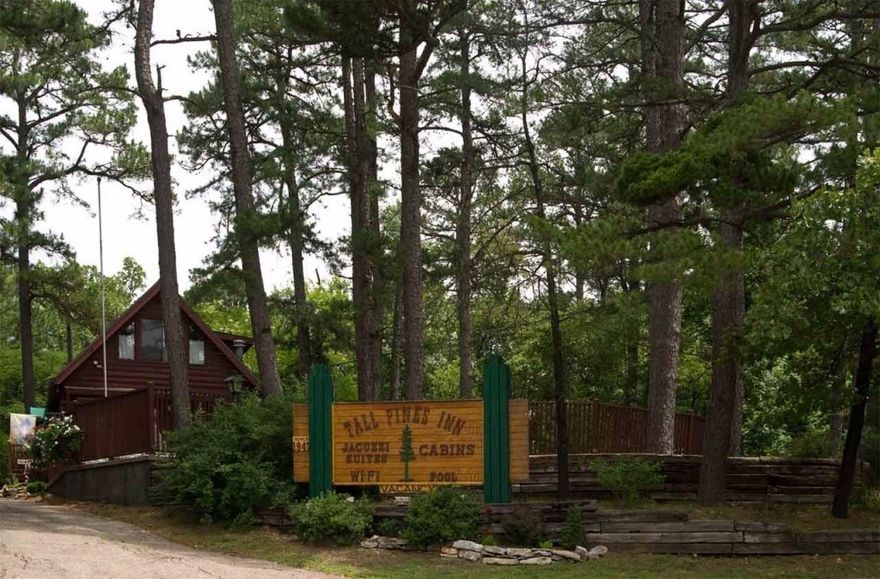 "Tall Pines Inn"  Beautiful wooded setting just minutes from downtown Eureka Springs.  Log Cabins, Jacuzzi Suites and Family Friendly cabins make up this fantastic lodging.  Each unit is heated and cooled, several have fireplaces, porches and decks.  There is a lovely heated pool, picnic area, trails, wifi, cable and even a trolley stop just outside your door.  The current owners have taken great care of this property.  Well established and ready for you to be the next owner.