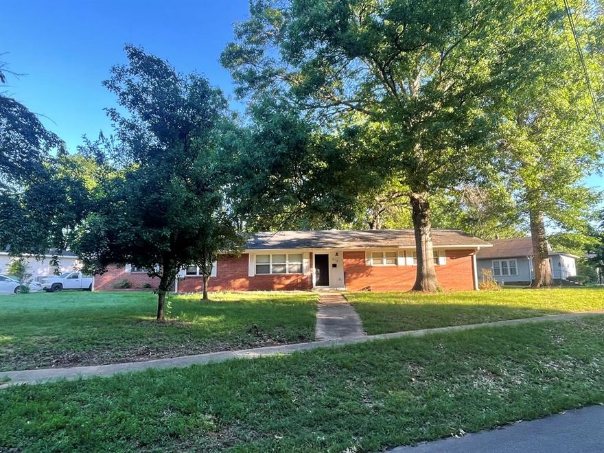 Stunning, 4 bedroom home hosts a gorgeous corner lot just west of the university. Extensively updated and remodeled, this dwelling offers four bedrooms, a den with built-ins and a fireplace. The house was extensively remodeled in 2022 with a new gas stove, granite countertops, under-mount sink and faucet, light fixtures, plus paint. Updated bathrooms with new toilets and double vanities in both, and new tile flooring installed also. Premium LVP flooring throughout. A new roof was installed in 2026. All appliances convey, including the washer and dryer. Hosting a fenced backyard, covered patio, and a garage plus storage throughout! FULL 24 NOTICE TO SHOW.