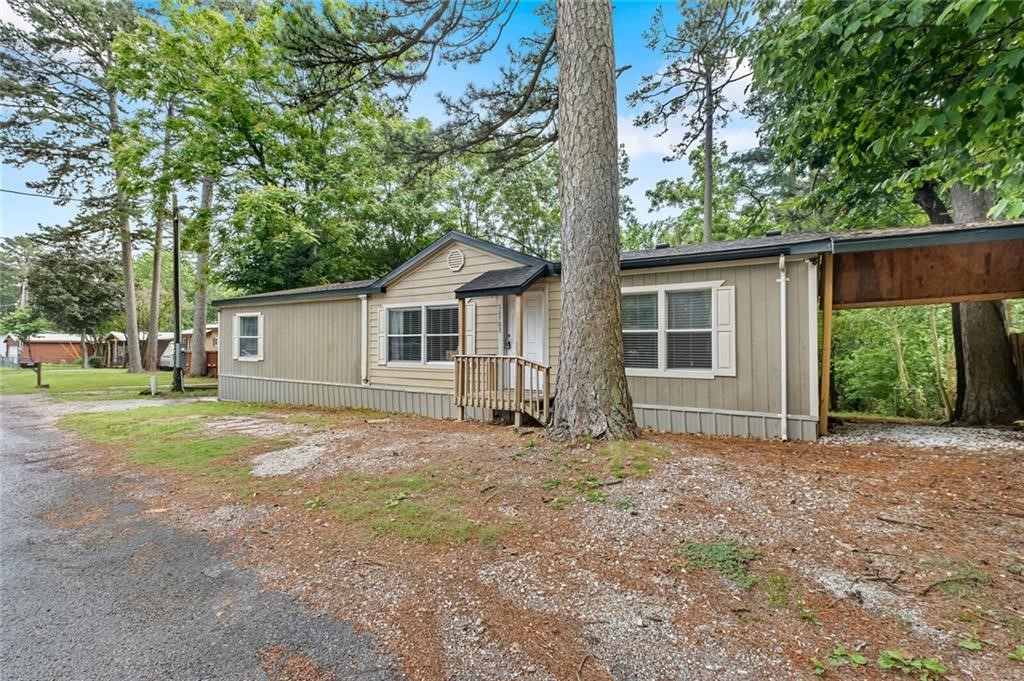 Perfect opportunity for first time home buyer or investor looking for a rental property, only minutes from Beaver Lake shore. Boat slip less than 2 miles away. This manufactured double wide was built in 2006. It is a 3 bedroom 2 full bath with 1,761 square feet of living space. Open concept layout & split floor plan. Spacious kitchen with ample cabinet space & dining space. Separate laundry room conveniently located off kitchen (Fridge, washer, & dryer included). A car port perfect for vehicle or RV parking on property. Architectural shingle roof is like new, less than 2 years old. A 10x22 back deck facing back yard landscape. Wont last long!