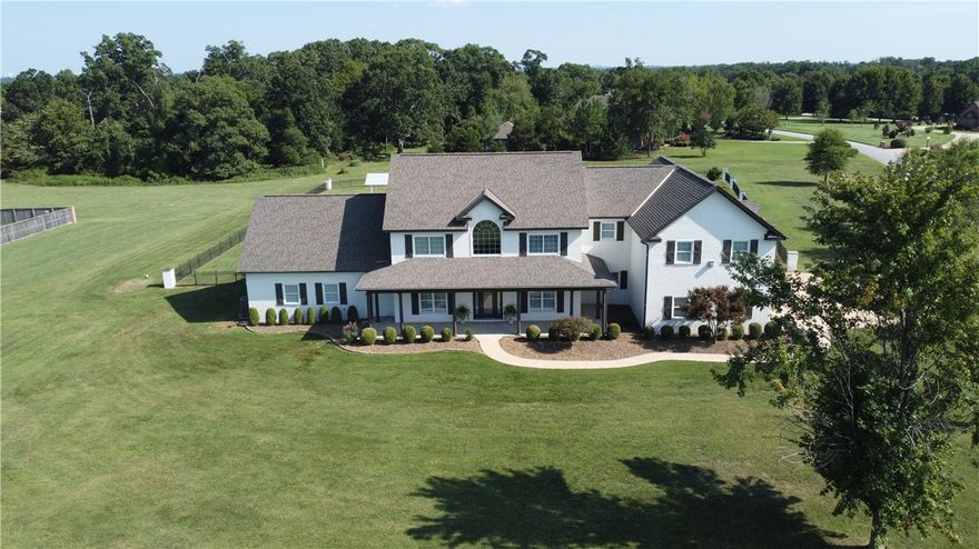 A gracious front porch welcomes you to come stay awhile in this beautiful estate in one of the prettiest neighborhoods in NWA! Entertaining is easy here between the formal dining, open kitchen w/ island overlooking the living, and screened in porch just off the eat-in. Staying clean and organized is a breeze. Kick off your shoes, drop your bags at the locker--dirty clothes go to the large laundry, and dirty dogs go to the dog wash in the separate mudroom just off the garage entrance. Wake up every morning to the sight of your sparkling blue swimming pool stretched out over the expansive estate sized lot.  In the winter cozy up in front of one of your two fireplaces or hang upstairs in the massive theater/game/workout room with its own bar ready to be stocked with afterschool snacks or drinks for the big game.  Upstairs you will also find 4 bedrooms ( one of which has its own en-suite bath & huge walk in closet), 2.5 bathrooms, & additional laundry room for convenience & ease.