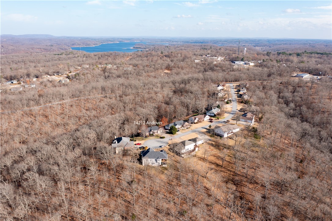 LAKE AREA AND CITY CONVENIENCE! Make your memories at this quiet Beaver Lake area property! Located minutes to Prairie Creek Marina and downtown Rogers on an 0.86-acre lot in a secluded cul-de-sac! Exterior features 2020 roof, brick, stone and siding, full guttering and covered & uncovered decks in the back to enjoy your private view of the trees on! Interior offers on the main level:entryway, formal dining room, an office with French doors, spacious living room with corner fireplace, kitchen with granite countertops and bar top, great cabinet space and eating area with bay window, laundry area with counterspace and cabinetry, 1/2 bath, ownerās suite with tray ceiling&crown molding, ownerās bath with wall-in shower, corner jetted tub, dual granite vanity and WIC on the lower level: 2nd living room with TV projector and screen with surround sound for your movie nights, 3 bedrooms with full bath with tiled walk-in shower, 1/2 bath, access to back decks and more! Call today and make it yours!