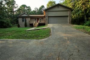 Private hillside home surrounded by nature but just a few minutes from town. With an open concept, cathedral ceilings, nice sized kitchen w/ a breakfast bar and a split floor plan for master bedroom privacy, this home has it all. The master suite features a large walk in closet and huge jetted tub for relaxing! There are two bedrooms on the opposite side of the house (one is currently set up for use as an office, but could be converted to a private bedroom very easily) with a shared bathroom. Add some new flooring and fresh paint to make it your own private paradise!