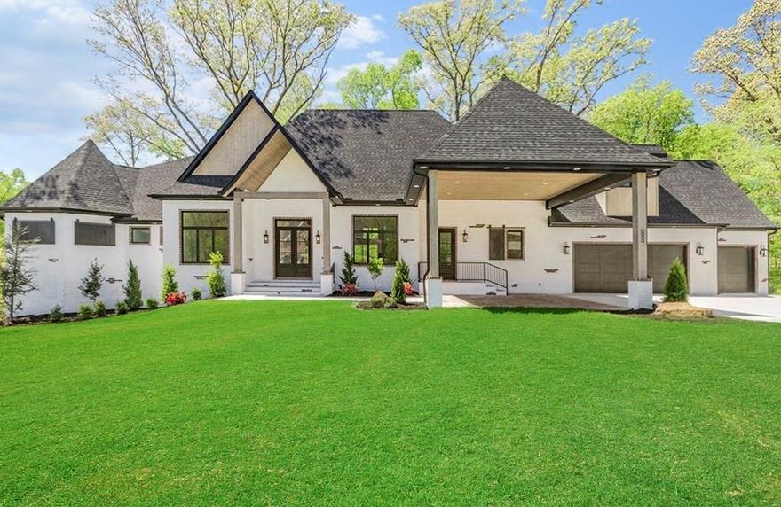 Luxurious meets modern and functional. Open concept living with soaring ceilings and wooded views. This well thought out design has so many gorgeous details throughout. 2900SF of wood flooring, double stairways, 5 total fireplaces. The gourmet kitchen features an expansive quartz island, custom cabinetry, double 30" commercial-style refrigerators, JennAir 48" pro gas range, and a butler's entry pantry. Laundry/utility rooms on both levels. Living Room, Kitchen, Formal Dining, Office, half bath, and a delightful Master Suite on the main level with an add'l bedroom and full bath that would make perfect media room. Walkout basement has a large game room, three bedrooms, three full baths and another laundry room. Covered outdoor space to be enjoyed from upstairs and down. Safe room w/ independent lock and tornado door. Insulated garage doors, epoxy flooring. Security ready, smart home. Just down the street from everything the Oak Tree community has to offer - pool, tennis, exercise room, playground, and clubhouse!