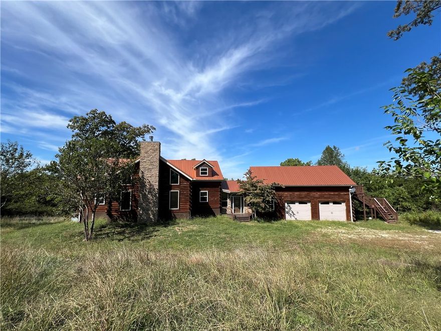 Check out this stunning lodge near Devil's Den State Park in West Fork.  The main house features 4 bedrooms & 3 full baths on three levels, and two enormous house-length covered decks.  Downstairs would make a great game area.  This property could be used as a family retreat, short term rental business, or development potential (buyer to confirm suitability with city and/or county).  2 bedroom, 1 bath garage apartment would be great for an extended or blended family or an additional income opportunity. Additional photos to follow soon.