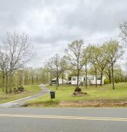 Enjoy quiet country living in this beautiful home on nearly 3 acres! This adorable doublewide mobile home is completely move in ready and has been well maintained! The living room is decked out with beautiful builtins. This home has an oversized carport with shop on one side. Just a few minutes to Lake Conway and Camp Robinson WMA. Plus, just a few miles from all the convinces of downtown Conway. Safe room, Generator and Home Security System are just a few extras this home has to offer.