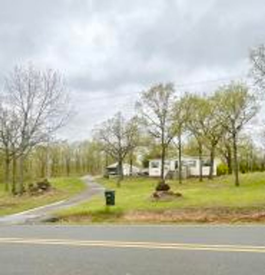Enjoy quiet country living in this beautiful home on nearly 3 acres! This adorable doublewide mobile home is completely move in ready and has been well maintained! The living room is decked out with beautiful builtins. This home has an oversized carport with shop on one side. Just a few minutes to Lake Conway and Camp Robinson WMA. Plus, just a few miles from all the convinces of downtown Conway. Safe room, Generator and Home Security System are just a few extras this home has to offer.
