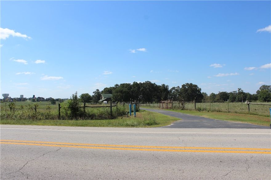 This charming farm house with beautiful architectural features has been updated over the years. Located 1.5 miles North of the new Bentonville West High School, 2 miles from new HWY549, and 5.8 miles from Walton BLVD, this is a prime development opportunity. With vaulted ceilings, granite, wood and bamboo  flooring, built-ins, loft, wood burning fire place, crown molding, and large outdoor entertainment areas, this house is a nice compliment to it's 51.48 acres listed as MLS#1057480. Priced to sell!