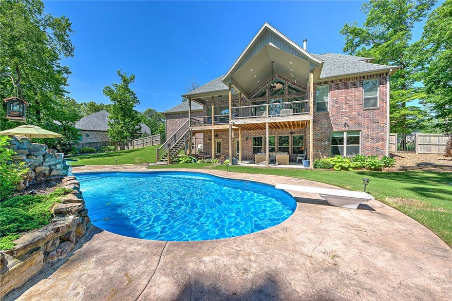 Welcome to luxury living in the coveted Versailles subdivision! Situated on a sprawling 2-acre lot with an incredible saltwater pool and four car garage, this stunning three level, four-bedroom, five-bathroom home epitomizes comfortable sophistication. Step inside to be greeted by soaring ceilings that open to giant windows showcasing the views beyond. The open-concept design seamlessly connects the living spaces, providing the perfect backdrop for both nights in and entertaining friends and family. The heart of the home is the kitchen, outfitted with a gas cooktop, double ovens, custom cabinetry, and center island. Downstairs, find the home office and large 2nd living area that opens onto the pool and backyard. Discover a private oasis with in-ground saltwater pool, surrounded by lush landscaping and towering trees. With meticulous attention to detail and luxurious finishes throughout, this Versailles estate offers the epitome of luxury living that still feels like home.