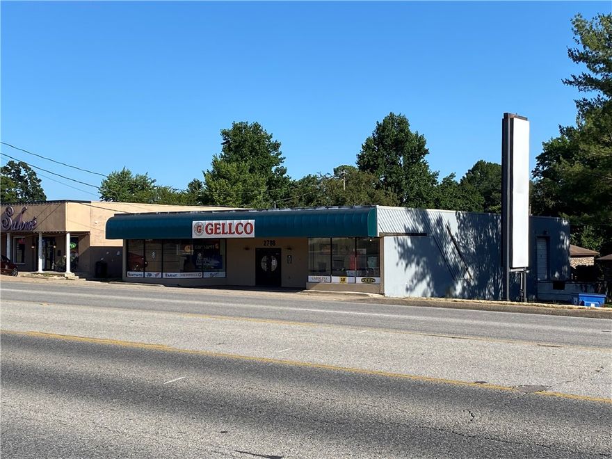 High visibility, easy access, Free Standing Retail - Commercial Building with surface parking and pylon sign. Currently occupied and leased to Gellco Work Clothing & Accessories.