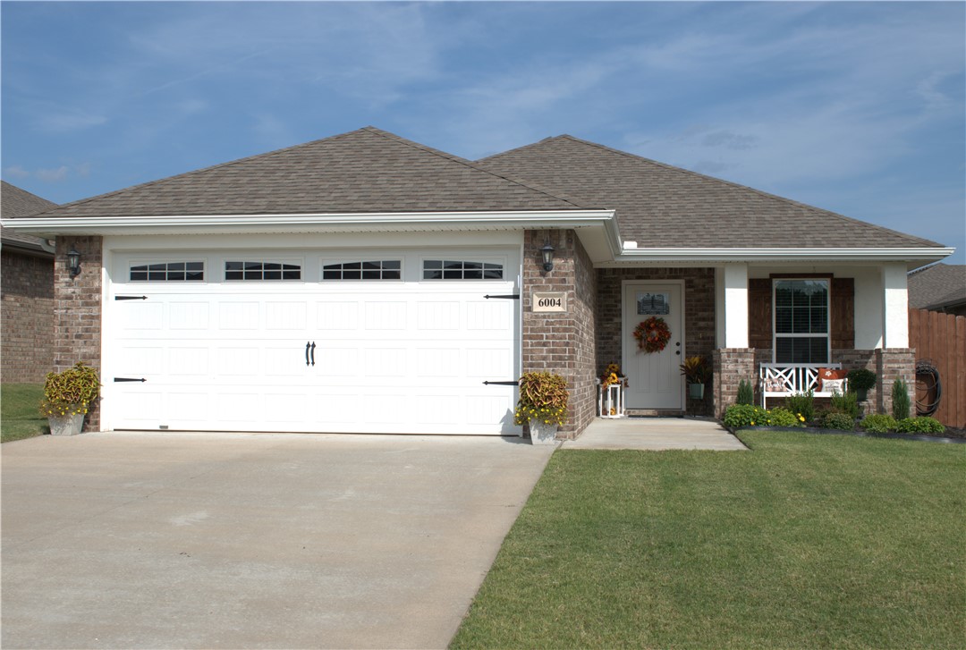 Immaculate brick home that has all the charm you could want! Spacious and open living room, kitchen and dining area includes island bar with seating, separate dining area, light wood pattern tile floors, granite counters, high ceilings with recessed lighting, upgraded cabinetry, and lighting. Main bedroom includes carpet, walk-in closet, private bathroom, and light and bright windows. Outside enjoy the oversized and partially covered patio off of the kitchen, perfect for grilling and entertaining. Privacy wood fence and gate. Enjoy the covered front porch that is fun to decorate for all seasons! Upgrades when purchased included lighting, gas heat, insulated garage, ceramic tile, extended back patio, and privacy fence. Refrigerator, washer and dryer will stay as a gift. Some furnishings negotiable. There is a dog park in the neighborhood and plenty of sidewalks! Such a great location outside the hustle and bustle of the city close to drive to your NW Arkansas destinations! This is a beautiful home!!! RD Eligible
