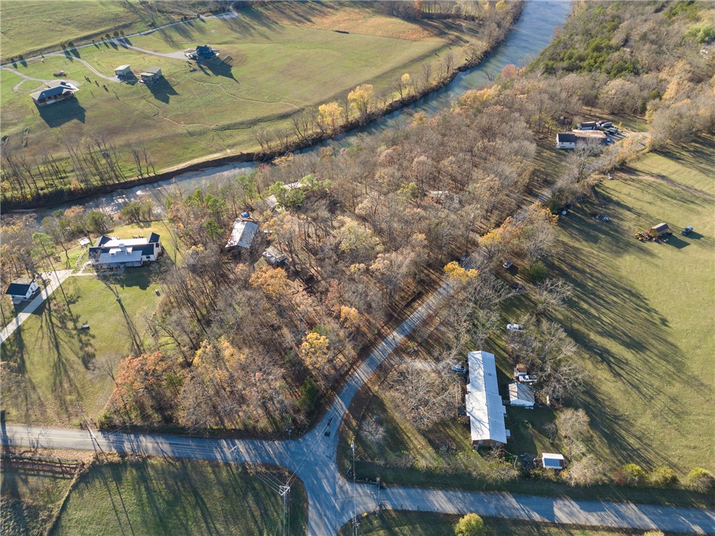Welcome to the Gathering Place at Cliff Springs! This exquisite 3544 sq.ft. home sits on 3.67 unrestricted acres, with private access to King's River. Main house as well as all other buildings on property come fully furnished. All Furnishings Convey! Newly remodeled addition, two kitchens upstairs, with a beautiful copper sink! Finished basement with industrial kitchen, and walk-out access to greenhouse, gardens, and the river! New roof in 2017. Upgrades include ON-DEMAND Hot Water Heater, 3 new heat pumps, and complement Central heat/air system. 30x50 Outbuilding for extra storage, 18x36 Pole shed, 292 sq.ft.Log Cabin 'Ozark Mountain Hideout' with Silo Shower. The Dream Weaver Air Stream with hot tub. A Western Theme Saloon! Metal Building with props and sliding barn doors. Alfresco dining pergola! This resort property can be run as a nightly rental with professional management with steady turnover. Walking trails and stairs lead to the river's edge. Minutes to Eureka Springs! Less than an hour to Branson!
