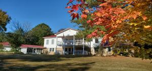 Residing on 9.4 picturesque acres with SHOP, this 4420 sqft residence is one of the most distinct properties around. Boasts of nostalgic farmhouse mixed with old world elegance. Constructed of reclaimed character timbers & stone, this 4 bdrm, 3 bth home is sure to amaze you. Remodeled kitchen w/leathered granite countertops, double oven, farmhouse sink. There are rock lined wood burning fireplaces in both living room & dining room areas to cozy up your home this time of year! Upstairs offers 2nd living area with a southern style covered deck overlooking the pond and mountains. Also upstairs is a cozy library loft & grand master suite with timeless clawfoot tub & giant walk-in closet. 2.5 mi to Illinois Bayou! This home has everything you would want for just good ole relaxed living!