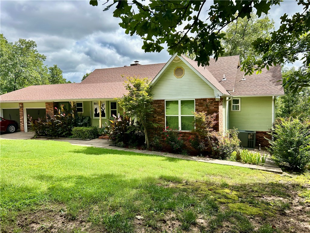 Custom-built home on the west side of Russellville! This beautifully landscaped 4bed, 2.5 bath home sits on 1.75 serene acres with a 125' driveway leading to an oversized 700 sq ft garage-insulated, with new doors/openers perfect for large trucks. A second driveway offers extra parking for an RV, boat, or guests. Features include 2X6 exterior walls, vaulted living room ceiling, gas fireplace, gas range, newer energy efficient HVAC, and a recently replaced 40 gal water heater. Enjoy relaxing on the large back deck or covered front porch!