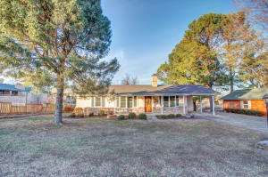 EXTREMELY WELL-KEPT HOME CLOSE TO TOWN! This 3BR/1.5BA home has a newer roof & a detached, 2-Car Garage/Workshop as well as an attached 1-car carport! Nice Hardwood floors in Kitchen, Pantry, Dining Room, and Hallways. Handy Pantry area attached to Kitchen with its own sink and LOTS of cabinet space! Wonderful see-through Gas Fireplace between the Living Room and Dining Room! New Refrigerator, and Electric Range are both less than a year old! AWESOME large deck with covered patio area over a hot tub that will convey! New carpet in first guest bedroom as well as new faucets in Master Bathroom, Hall Bathroom and Kitchen!