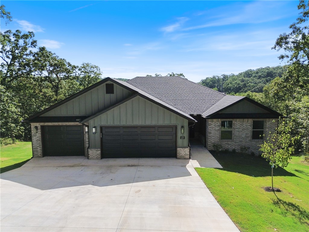 Take a look at this beautiful, brand-new home, tucked away among lovely trees in a peaceful setting! Inside, you'll find a spacious 1,806 square foot layout with three bedrooms and two bathrooms. The open-concept kitchen and living area invites you to gather with friends and family, complete with a vaulted ceiling and a warm fireplace. And with a roomy three-car garage, there's plenty of space for your cars and hobbies! You’ll be close to the Tunnel Vision bike trail and just a short drive from all the fun Northwest Arkansas offers. This home gives you the perfect mix of privacy and convenience!