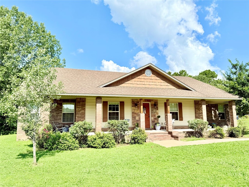 Beautiful, well-maintained home situated on just under 4 acres. This spacious 3-bedroom, 2-bathroom home features an open floor plan with vaulted ceilings and walk-in closets throughout. The kitchen offers eye-catching two-toned cabinetry and an oversized pantry/storage room. The primary suite includes double vanities, a large jetted tub, and dual walk-in closets. A Jack-and-Jill bathroom connects the two additional bedrooms, providing a functional and family-friendly layout. Enjoy the peaceful setting from the large front and back porches. Ample storage and thoughtful design make this home a standout.