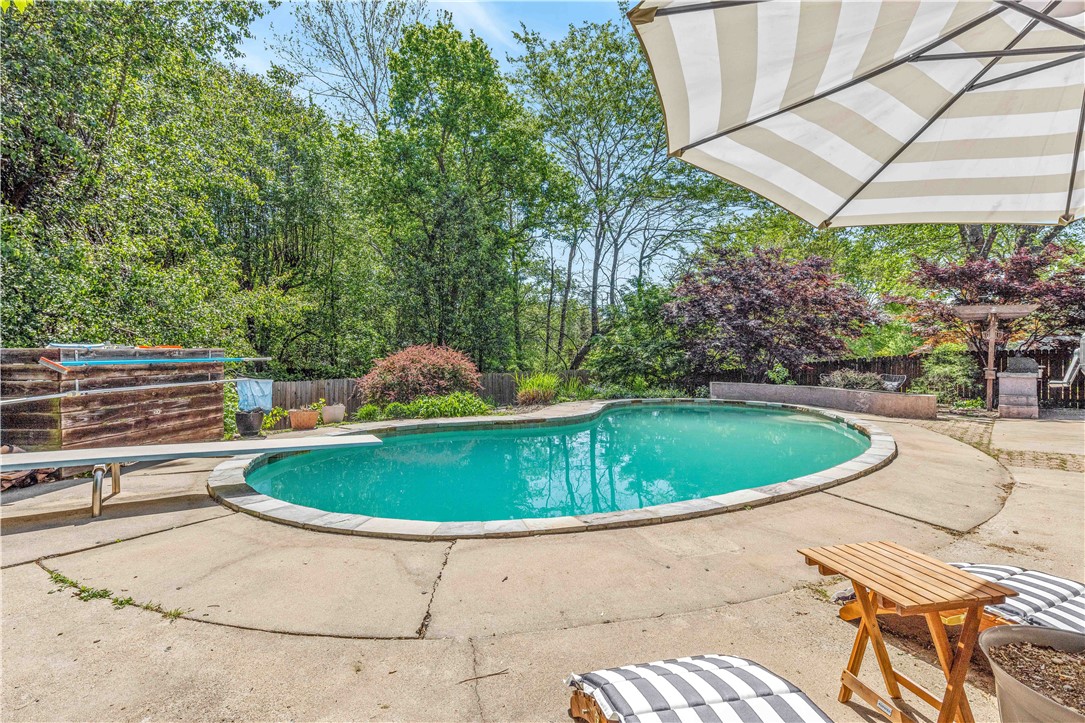 This backyard oasis with inground pool is available just in time for summer! Entertain friends and family in the large, private backyard complete with patio for lounging by the pool, cooking out on the custom built in grill area and cozying up by a fire in the shared seating space. This home brings a modern, unique vibe with open floor plan living, nothing cookie cutter here! Exterior siding, roof, water heater, pool equipment and high quality durable ceramic tile floors downstairs were all replaced since 2020. NO carpet here! There are two bedrooms upstairs with one acting as a guest suite with its own full bath. Primary owner's suite is downstairs with large bonus room. Kitchen boosts granite countertops and oversized custom pantry. Pool area has access to 220V for hot tub installation. Refrigerator, ADT system (equipment only) and interior built-in speaker / music system convey. Geography cannot get much better, centrally located just off of 71B and offers quick access to I49. Run, don't walk to DIVE RIGHT IN!