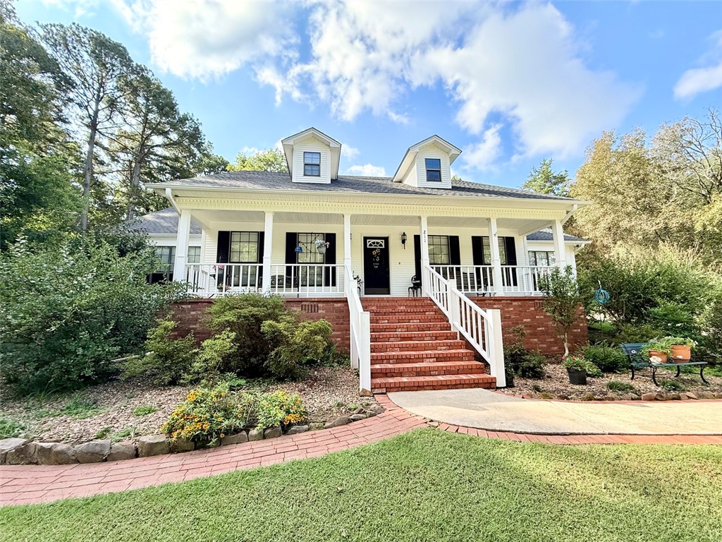 Welcome to this charming 4-bedroom, 2.5-bathroom home nestled in the desirable Hickory Hills Subdivision. Situated on a quiet dead-end road, this 2,324 sq. ft. property offers the perfect blend of comfort and privacy in a friendly neighborhood. Inside, you’ll find a spacious living room with tall ceilings and a cozy fireplace, creating a warm and inviting atmosphere. The split floor plan provides plenty of room for everyone, including a primary suite with an attached full bathroom and walk-in closet. A formal dining area, eat-in kitchen, and 2-car garage add both function and convenience. Step outside to enjoy the beautifully landscaped backyard, complete with walking paths that extend around to the front of the home. The outdoor spaces are ideal for relaxation, entertaining, or simply enjoying the peaceful surroundings. This property offers space, comfort, and curb appeal—a perfect place to call home in Russellville.