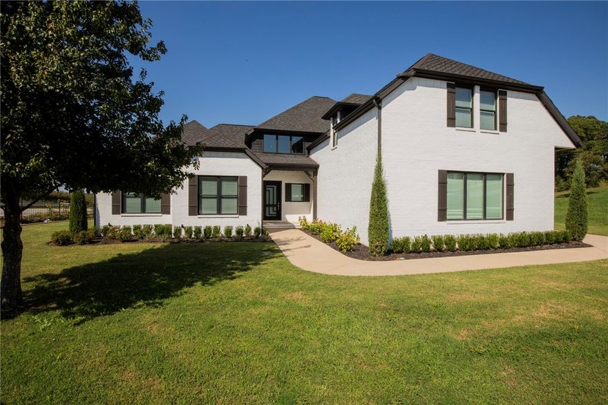 This stunning home in Pinnacle offers a modern open floor plan and chef-designed gourmet kitchen by a famous local chef, featuring a professional Frigidaire built-in refrigerator/freezer and a DCS by Fisher & Paykel professional range and hood. With 4 bedrooms plus a bonus room that can serve as a 5th, there’s flexibility for every need. The main level includes 2 bedrooms, office, dining, spacious laundry, and 2 fireplaces. The master suite boasts heated tile shower floors for ultimate comfort. Hardwood floors flow throughout the main level, staircase, and upstairs hallway. Upstairs you’ll find 2 bedrooms, a bonus/5th bedroom, and abundant storage. Entertain outdoors with a covered deck and fireplace. Convenient rear gate access and a prime location in the Bentonville School District make this home exceptional.