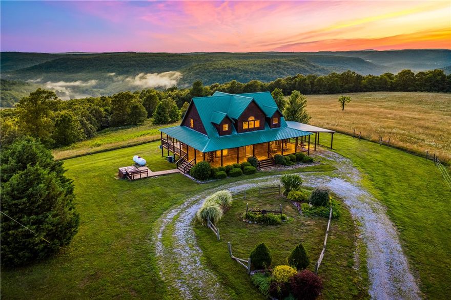 Located just 6 miles from Ponca and the Buffalo National River, this is one of the nicest properties in Newton County AR! This 563 m/l acres offers it all! From the new asphalt driveway leading from a paved highway up to the main lodge with views, mountain top pastures, deep woods with bluffs and creeks to a year-round spring-fed pond that maintains it's level even in drought, you have it all! The beautiful cedar log cabin lodge is a Hostettler masterpiece with custom built solid wood doors, cabinets and cedar accents throughout as well as cedar walls and a cat walk! Pine floors, nice appliances, a master suite with a garden tub of it's own, walk-in closet and it's own sliding doors going to the wrap-around covered veranda. Or enjoy the hot tub under the stars. This comes fully