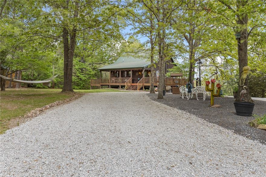If you’ve been dreaming of a peaceful retreat with unforgettable views, this 3-bedroom, 2-bath log cabin on over seven park-like acres delivers. A full four-sided wraparound porch offers stunning views of the Tyler Bend area of the Buffalo National River. Located just five minutes from Gilbert and Grinder’s Ferry access and moments from Tyler Bend, you’ll enjoy easy access to some of the river’s most loved destinations. You’re also just minutes from local favorites—Ferguson’s Country Store and Coursey’s Smoked Meats.
An additional homesite at the front of the property already has utilities in place—perfect for a guest house or income-producing rental. The lower level features a bedroom/family room combo with its own kitchen and private outdoor access, ideal for guests or multi-generational living.
Extras include an RV hookup, two-car carport, outbuilding, and shed. Whether you're looking for a full-time home, weekend getaway, or investment, this one checks all the boxes.