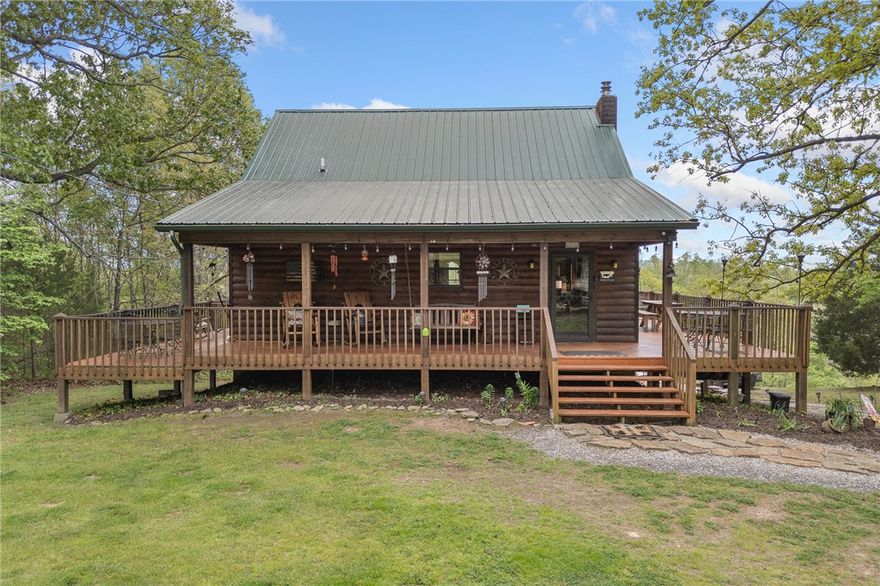 If you’ve been dreaming of a peaceful retreat with unforgettable views, this 3-bedroom, 2-bath log cabin on over seven park-like acres delivers. A full four-sided wraparound porch offers stunning views of the Tyler Bend area of the Buffalo National River. Located just five minutes from Gilbert and Grinder’s Ferry access and moments from Tyler Bend, you’ll enjoy easy access to some of the river’s most loved destinations. You’re also just minutes from local favorites—Ferguson’s Country Store and Coursey’s Smoked Meats.
An additional homesite at the front of the property already has utilities in place—perfect for a guest house or income-producing rental. The lower level features a bedroom/family room combo with its own kitchen and private outdoor access, ideal for guests or multi-generational living.
Extras include an RV hookup, two-car carport, outbuilding, and shed. Whether you're looking for a full-time home, weekend getaway, or investment, this one checks all the boxes.