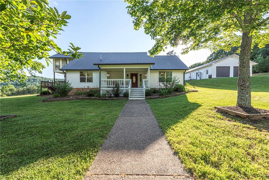 This UPDATED 5 bd 3 ba home on 87.76 ac. w/ 5 ponds & 2 bd 1 bath apartment, is 20 min from University of Arkansas & all the city amenities your heart could desire—yet tucked in the countryside! From the covered front porch head inside to spacious living w/ wood flrs, formal dining rm, beautiful kitchen w/ stainless steel apps, butcher block island, new counters & tiled bksplsh 2nd living rm perfect for entertaining! 4 bedrms & 2 remodeled bathrms on main flr! Upstairs, retreat in the large primary w/ redesigned bathrm w/ double sink vanity, walk-in shower, & your own all-season rm w/ wood-accents & new sliding door to private upper-level deck! Head out to the newly replaced back deck overlooking lush pasture, stunning Ozark Mtns, & the stars that put on a show! 2 car detached garage w/ 2bd 1 bath apartment w/ covered porch, living, kitchen, dining & laundry hookup & new metal roof & fresh ext paint! Whether you’re dreaming of a homestead, hobby farm, or want space in the Natural State, this property delivers!